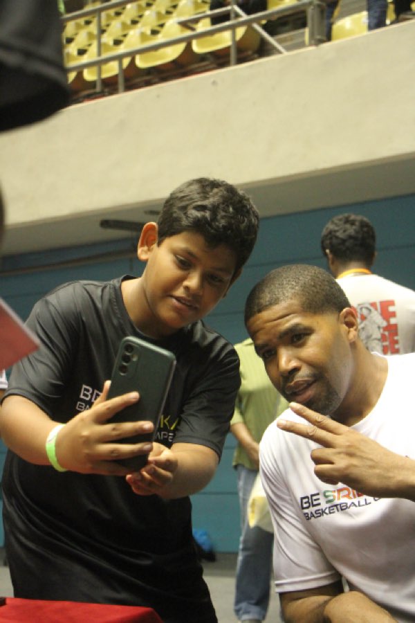 Coach JJ with a player at the camp